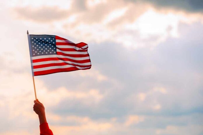 Hand,Waving,The,Flag,Of,The,United,Stated,Of,America.