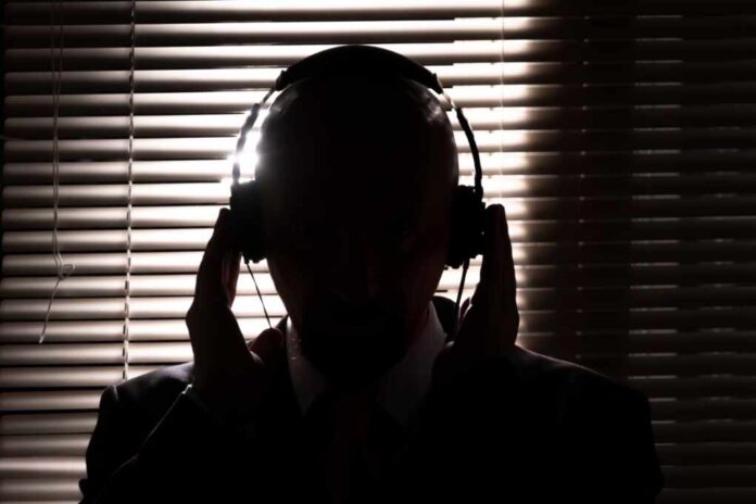 Silhouette,Of,An,Fbi,Secret,Agent,,Listening,With,Headphones,And