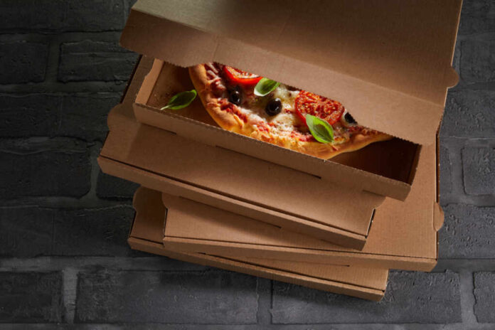 Italian,Pizza,Packed,Ready,To,Go,In,A,Brown,Cardboard