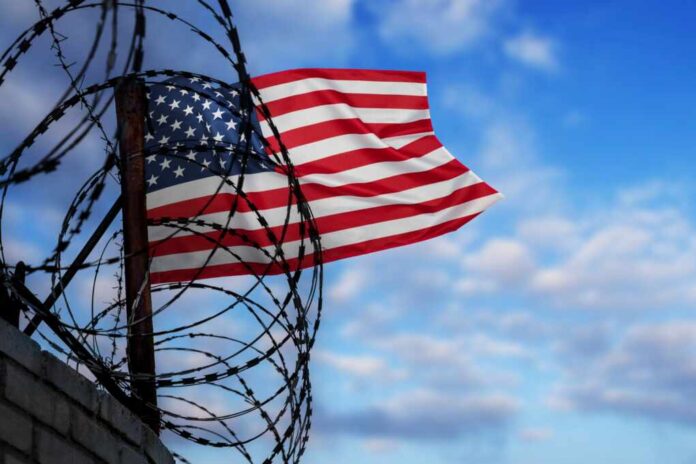Wall,With,Barbed,Wire,And,Us,Flag.,Concept,Of,Problems