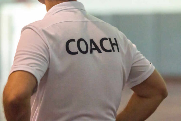 Back,View,Of,Male,Sport,Coach,With,Word,Coach,Written