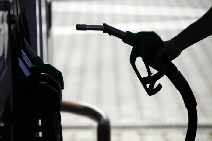 Detail,Of,A,Hand,Holding,A,Fuel,Pump,At,A