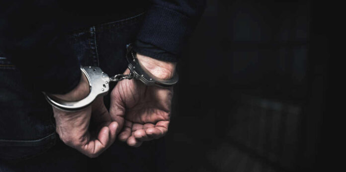 Handcuffed,Arrested,Man,Behind,Prison,Bars.,Copy,Space