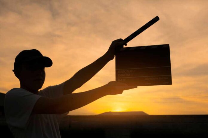 Teenage,Boy,Holding,A,Film,Slate,Or,Film,Clapper,Board