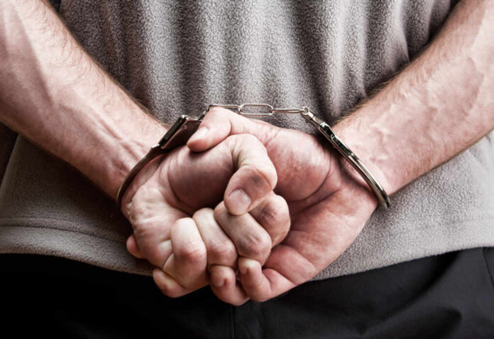 Criminal,Hands,Locked,In,Handcuffs.,Close-up,View