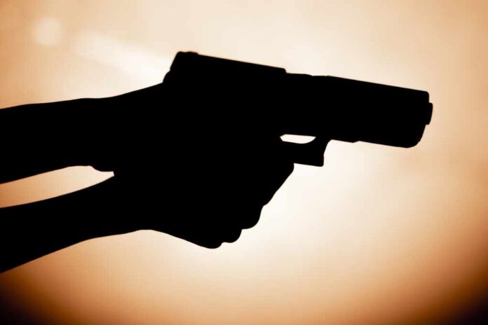 Close-up,Of,Female,Hands,Holding,Pistol,Contrast,Light,Readiness,To