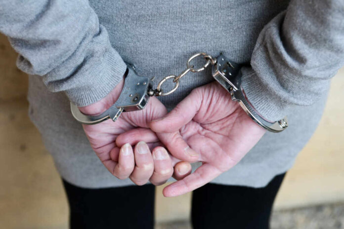 Arrested,Woman,In,Handcuffs,Behind,Her,Back