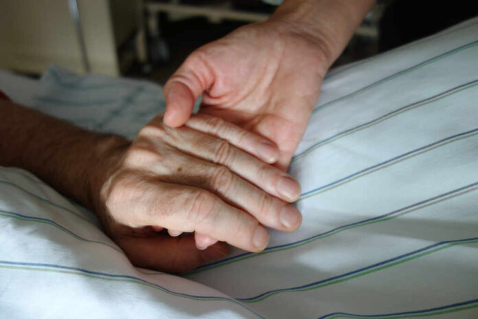 Nurse,Holding,A,Hand,Of,A,Patient