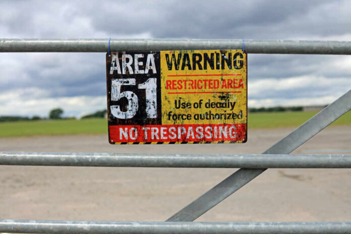 Vintage,Area,51,Warning,Sign,Hanging,On,A,Gate.,Extraterrestrial