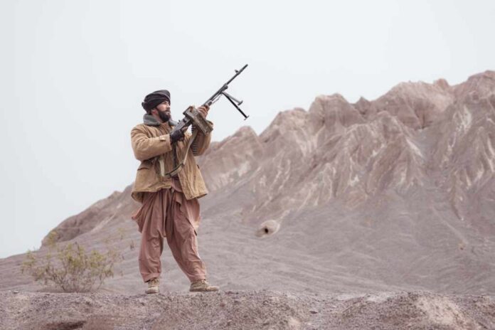 A,Taliban,Soldier,Stands,With,A,Machine,Gun,,In,The