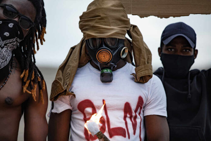 Afroamerican,Men,Hold,Burning,Glass,Bottle,In,Hands,,Absolute,Chaos