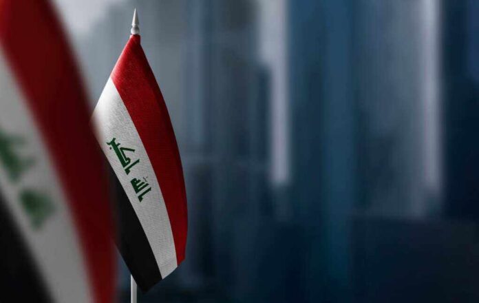 Small,Flags,Of,Iraq,On,A,Blurry,Background,Of,The