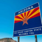 Welcome sign for Arizona with a blue sky background