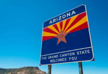 Welcome sign for Arizona with a blue sky background