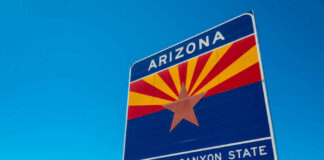 Welcome sign for Arizona with a blue sky background