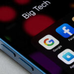 Close-up of a smartphone screen displaying various app icons including Google, Facebook, and Netflix