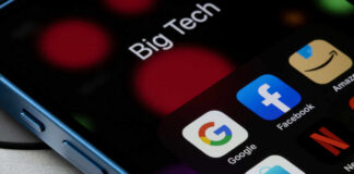 Close-up of a smartphone screen displaying various app icons including Google, Facebook, and Netflix