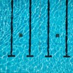 Aerial view of a swimming pool with clear blue water and lane markers