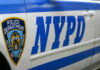 Close-up of a New York Police Department vehicle with badge and NYPD lettering