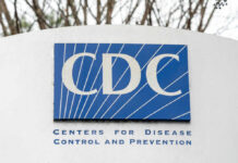 Sign displaying the CDC logo and full name, Centers for Disease Control and Prevention