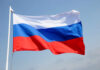 Russian flag waving against a clear blue sky
