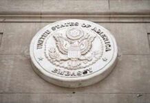 Seal of the United States Embassy displayed on a wall