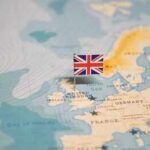 A map of Europe with a small flag of the United Kingdom pinned on it