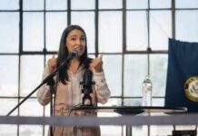 A woman speaking passionately at a podium with a microphone