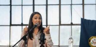 A woman speaking passionately at a podium with a microphone