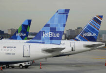 Three jetBlue aircraft tails lined up at an airport