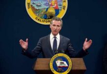 California governor delivering a speech at a podium