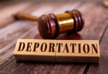 Wooden blocks spelling 'DEPORTATION' next to a gavel on a wooden surface