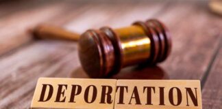 Wooden blocks spelling 'DEPORTATION' next to a gavel on a wooden surface