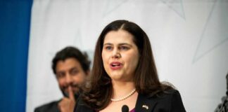 A woman speaking at a podium during a public event
