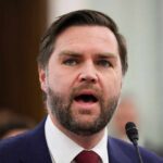 $19 Billion Fraud Allegation Shocks Minneapolis A man in a suit passionately speaking at a podium
