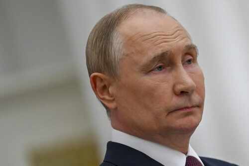 A serious-looking man in formal attire with a neutral expression