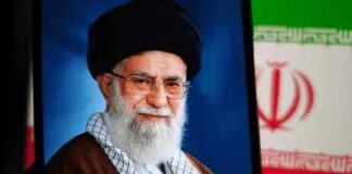 Portrait of a political leader with a black turban and glasses