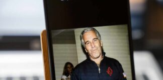 A man in casual attire smiling at the camera