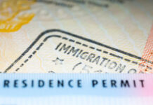 Biden’s Border Crisis: 3.5 Million Left in Limbo Close-up of a residence permit showing immigration details