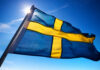 Swedish flag waving against a clear blue sky