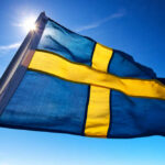Swedish flag waving against a clear blue sky