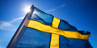 Swedish flag waving against a clear blue sky
