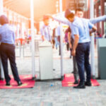 Airport security personnel assisting passengers at a checkpoint
