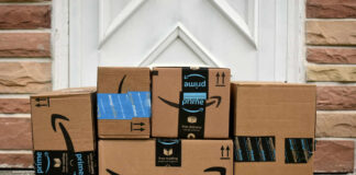 Stack of Amazon delivery boxes on a front porch
