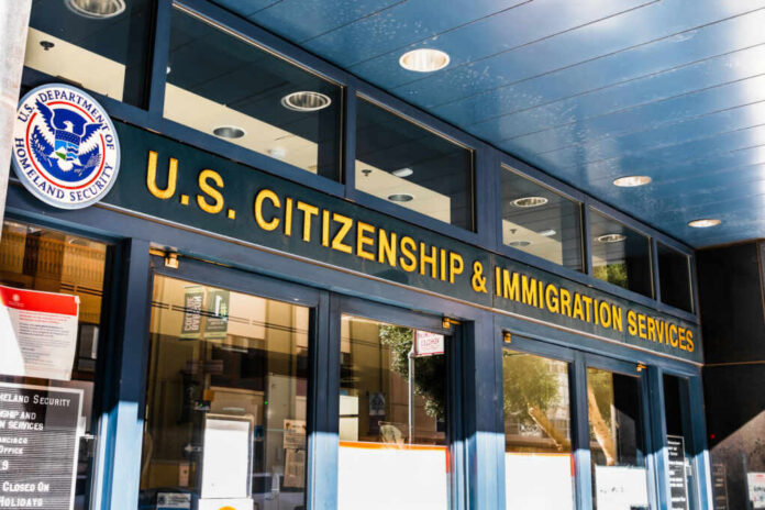 shutterstock_1569360250.jpg Entrance of the U.S. Citizenship and Immigration Services office with signage