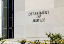 Sign on the exterior wall of the Department of Justice building