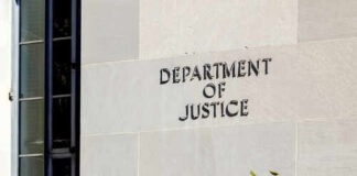 Sign on the exterior wall of the Department of Justice building
