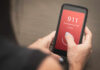 Person making an emergency call to 911 on a smartphone