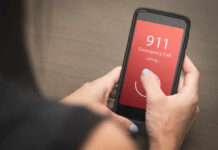 Person making an emergency call to 911 on a smartphone