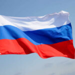 Russian flag waving against a clear blue sky